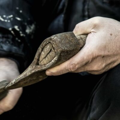 Sharpening a hatchet with a whetstone