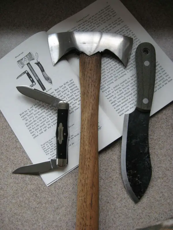 A Nessmuk trio of double bit hatchet and fixed-blade and folding knives