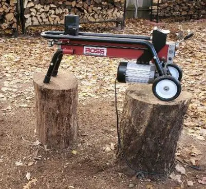 Storing Boss Industrial Log Splitter on a stand made up of wooden logs