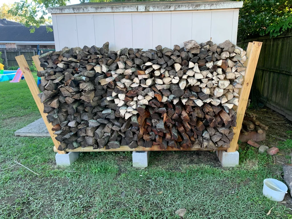 an example of a wooden firewood rack filled with firewood logs