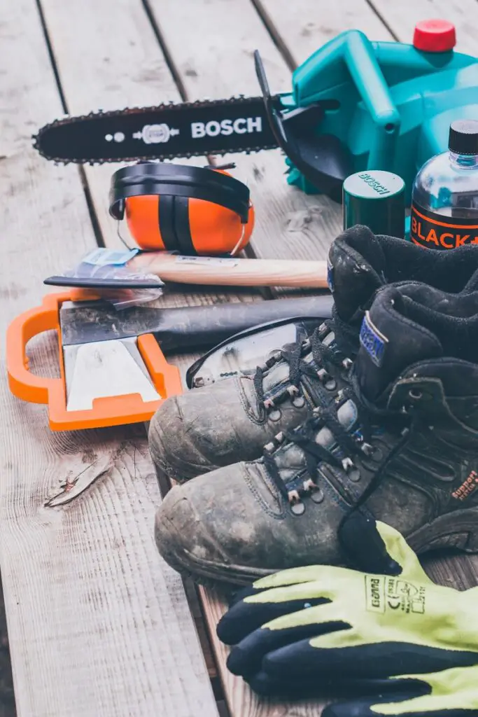 an axe, a chainsaw, and safety gear